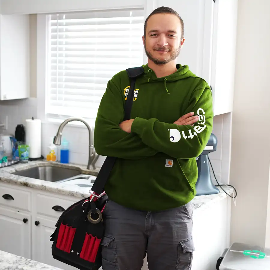 Plumber standing in front of sink.  